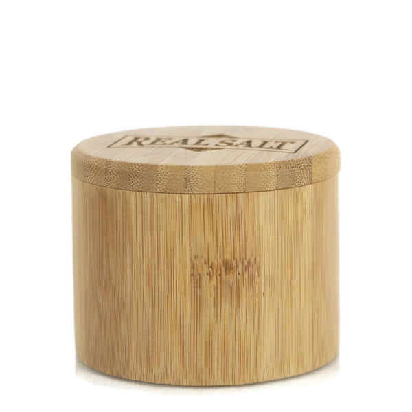 Round bamboo salt container with lid. The lid features the words "Real Salt" engraved on top. 
