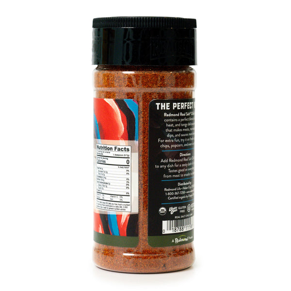A clear jar displays a vibrant blend of Redmond Real Salt Chili Lime Seasoning, ready to add a kick to any dish. 
