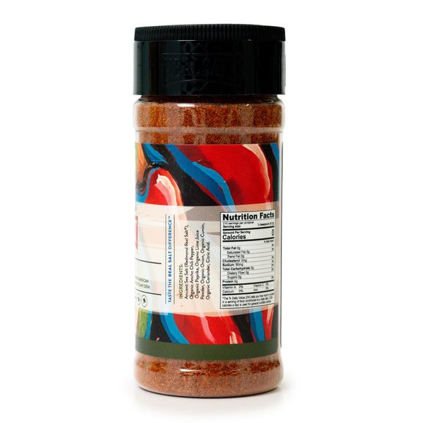 Clear glass jar of Real Salt's organic Taco Blend seasoning showcasing the ingredient list and nutritional facts label. 
