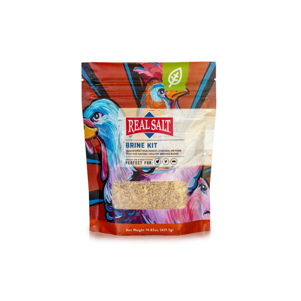 Real Salt Brine Kit stands in a colorful package, featuring illustrations of a chicken and pig, showcasing the savory blend perfect for brining poultry and pork. 
