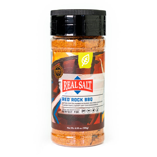 A jar of Real Salt Red Rock BBQ rub sits against a white background, showcasing its vibrant label and keto-friendly ingredients. 
