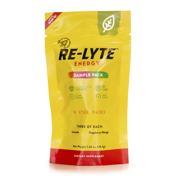 A bright yellow sample pack of Re-Lyte ENERGY stick packs stands upright against a white background. 
