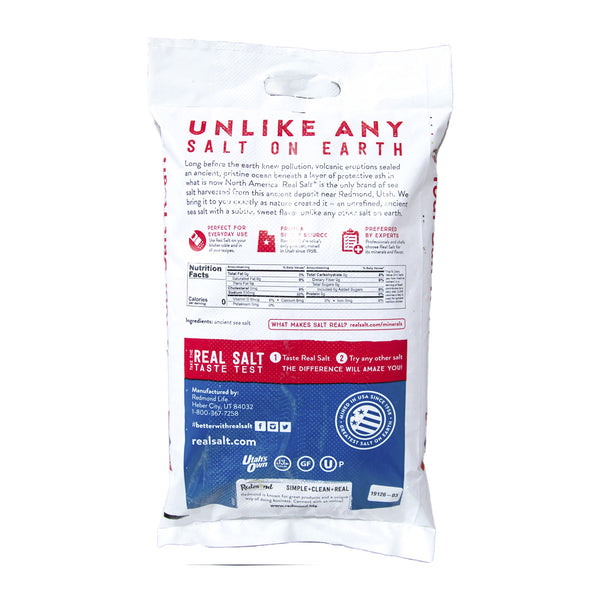 White bag of Redmond Real Salt displaying the nutritional information and sourcing of the ancient sea salt. 
